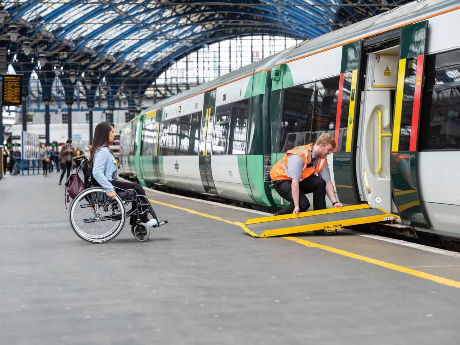 GTR staff and customer at station